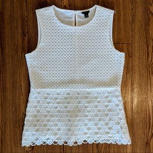 Sleeveless white dot cutout top with peplum